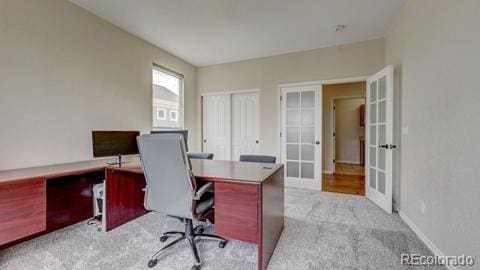 carpeted home office with french doors