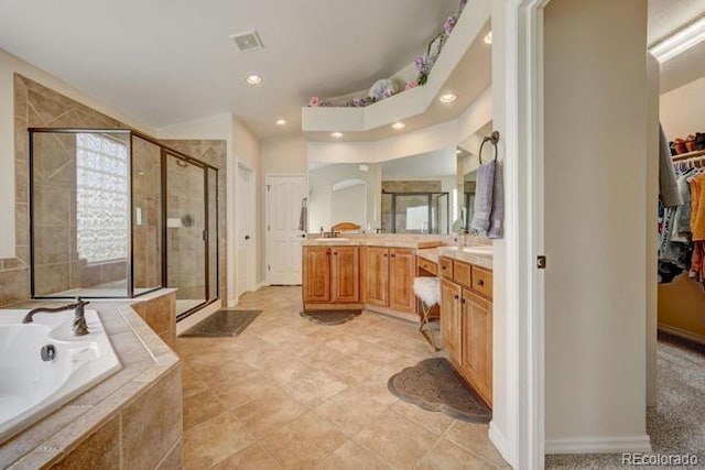 bathroom featuring shower with separate bathtub and vanity