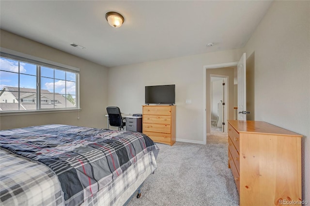 bedroom featuring light carpet