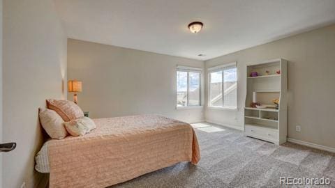 bedroom with light colored carpet