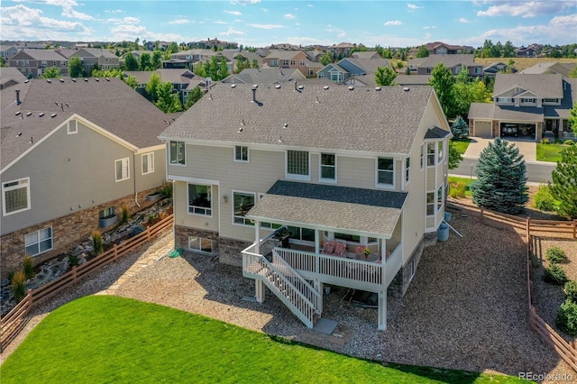 rear view of property featuring a lawn