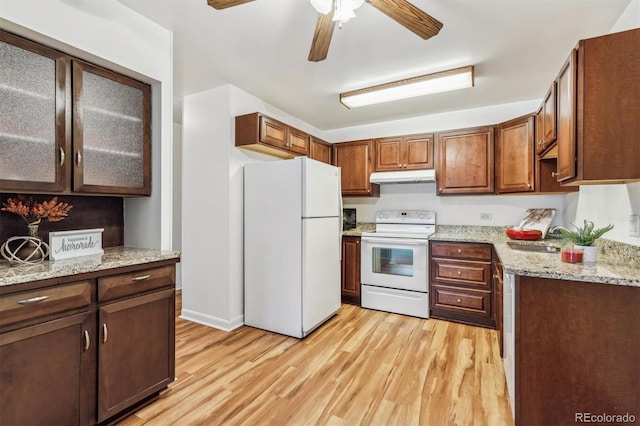 610 S Alton Way Unit 8D, Denver, CO 80247 - kitchen with white appliances, under cabinet range hood, light wood-style floors, ceiling fan, and light stone countertops