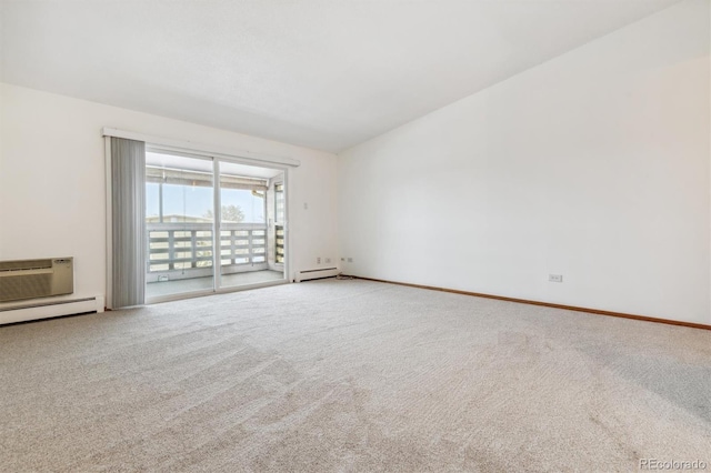 spare room featuring vaulted ceiling, a wall unit AC, and carpet flooring