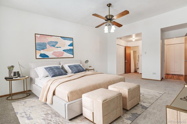 bedroom with a ceiling fan, light colored carpet, and baseboards