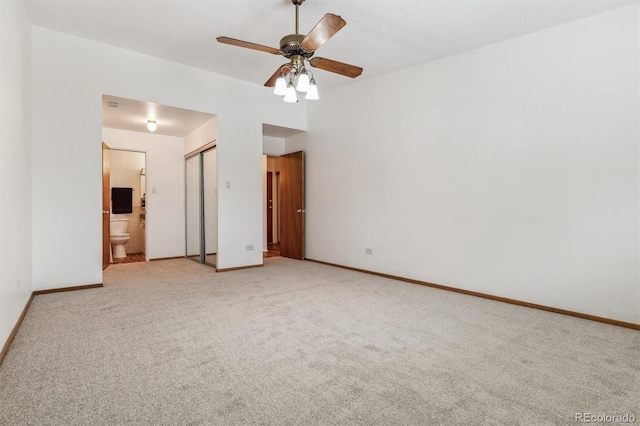 spare room featuring carpet floors, ceiling fan, and baseboards