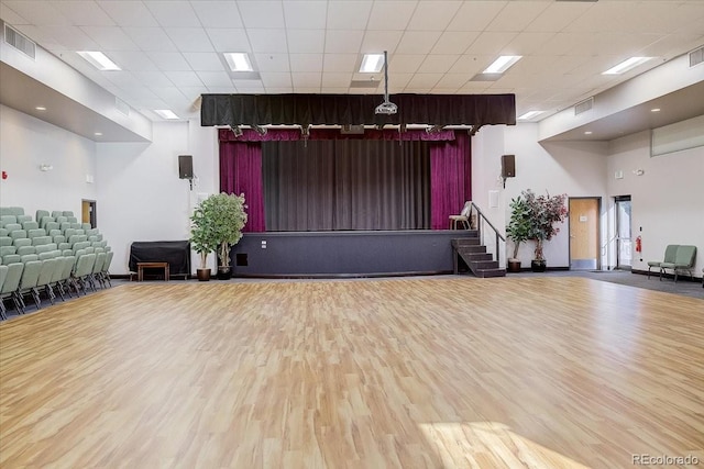 miscellaneous room featuring a paneled ceiling, visible vents, stairway, and wood finished floors