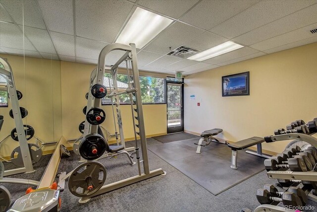 gym featuring a drop ceiling, visible vents, and baseboards