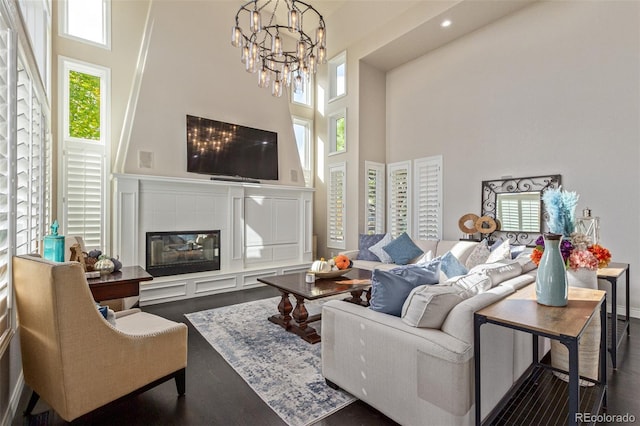 618 Fairchild Dr, Highlands Ranch, CO 80126 - living area with a chandelier, a wealth of natural light, a towering ceiling, and dark wood-type flooring