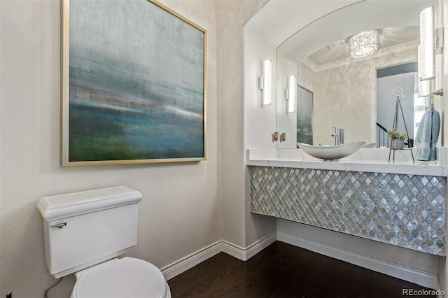 618 Fairchild Dr, Highlands Ranch, CO 80126 - half bathroom with baseboards, toilet, wood finished floors, and a sink
