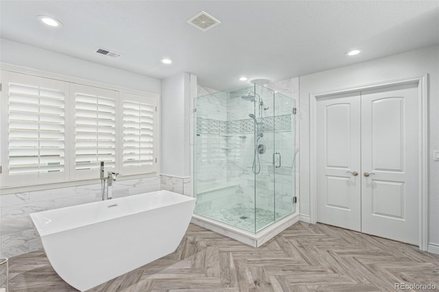 618 Fairchild Dr, Highlands Ranch, CO 80126 - bathroom featuring a freestanding tub, visible vents, and recessed lighting
