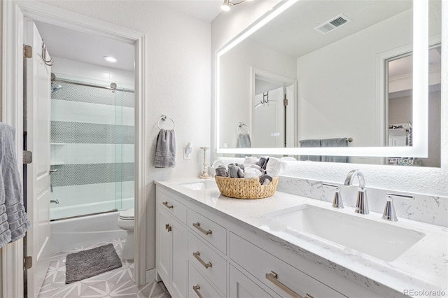 618 Fairchild Dr, Highlands Ranch, CO 80126 - full bathroom with a sink, double vanity, toilet, visible vents, and combined bath / shower with glass door