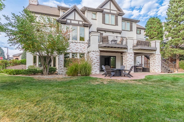 618 Fairchild Dr, Highlands Ranch, CO 80126 - rear view of property featuring stairway, a balcony, a yard, and a patio