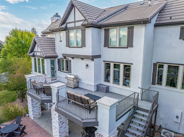 618 Fairchild Dr, Highlands Ranch, CO 80126 - rear view of property with a tiled roof, a patio, a chimney, and stucco siding