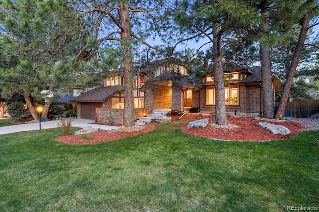 prairie-style home with a front yard and a garage