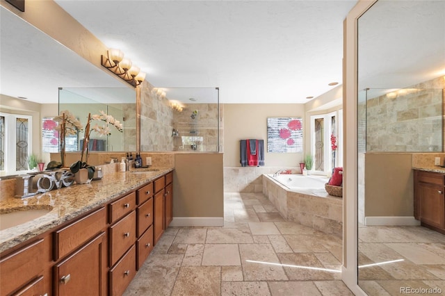 bathroom featuring vanity and independent shower and bath