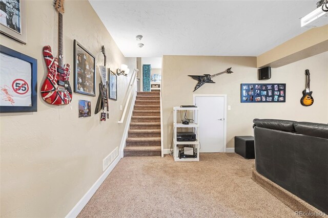 hallway featuring carpet and a textured ceiling