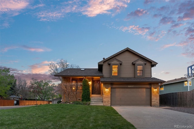 12017 W Cross Dr, Littleton, CO 80127 - tri-level home with brick siding, a garage, and driveway