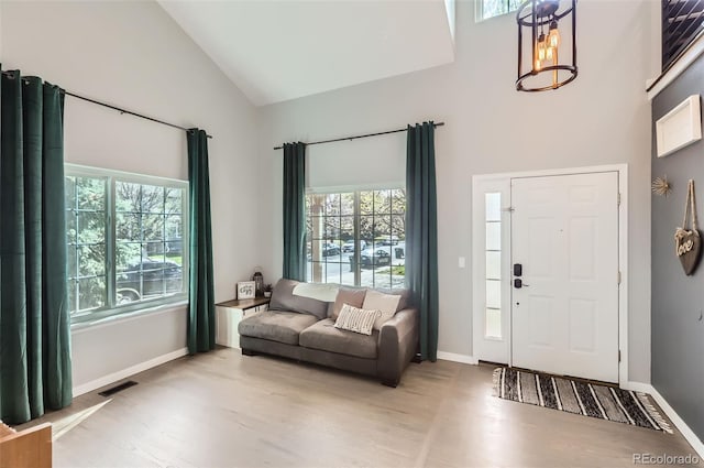 3805 E 106th Ave, Thornton, CO 80233 - entrance foyer with a wealth of natural light, wood finished floors, visible vents, and high vaulted ceiling