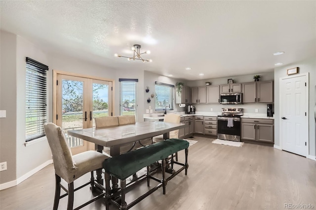 3805 E 106th Ave, Thornton, CO 80233 - dining room featuring french doors, light wood-style flooring, baseboards, a chandelier, and recessed lighting