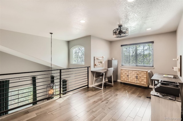3805 E 106th Ave, Thornton, CO 80233 - bonus room featuring a textured ceiling, plenty of natural light, and wood finished floors