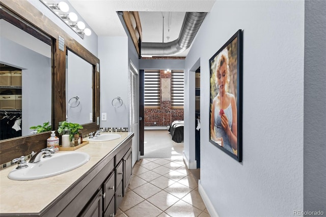 bathroom with tile patterned floors and vanity