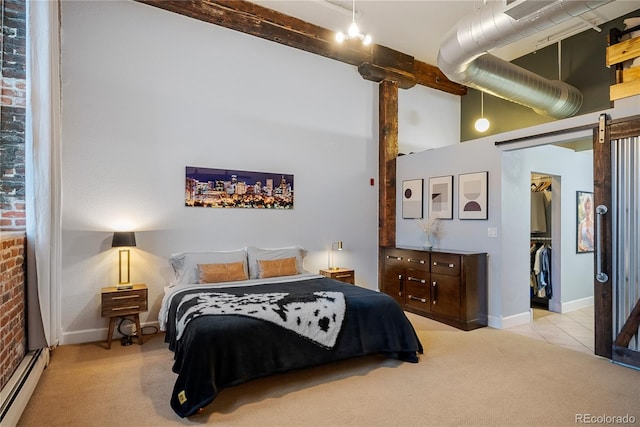 bedroom featuring light carpet, brick wall, baseboard heating, beam ceiling, and a spacious closet