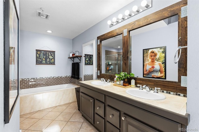 bathroom featuring tile patterned flooring, vanity, and separate shower and tub