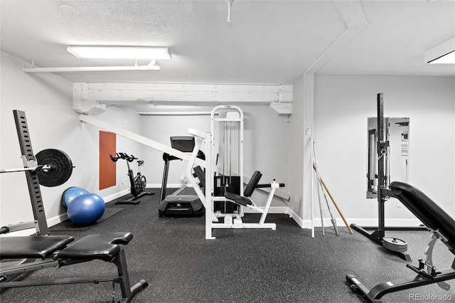 exercise room featuring a textured ceiling