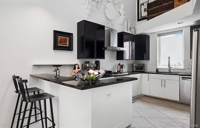790 N Clarkson St Unit 206, Denver, CO 80218 - kitchen with a sink, wall chimney exhaust hood, stainless steel dishwasher, a kitchen bar, and dark countertops