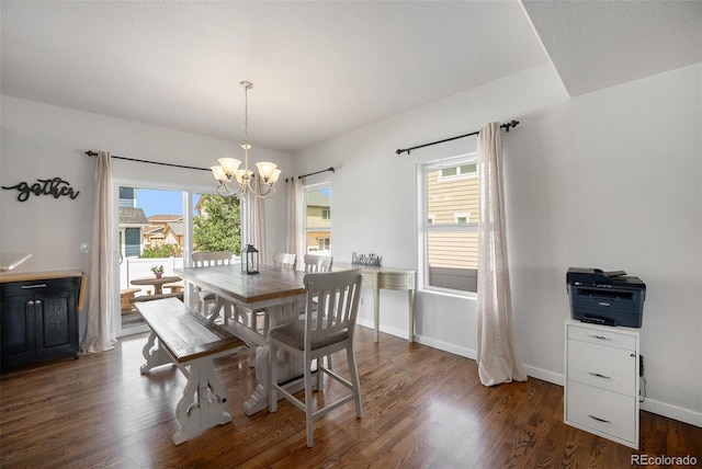 dining space featuring a chandelier, healthy amount of natural light, dark wood-type flooring, and baseboards