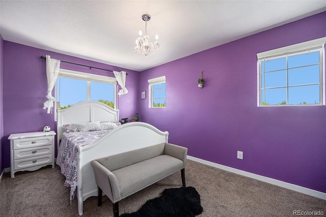 bedroom featuring a chandelier, carpet, and baseboards