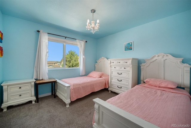 bedroom with dark colored carpet, a chandelier, and baseboards