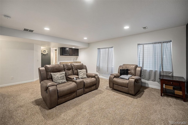 living area with light colored carpet, baseboards, recessed lighting, and bar area