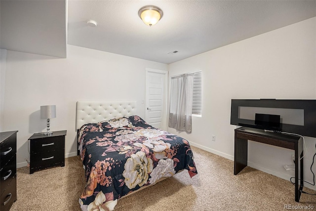 bedroom featuring carpet and baseboards