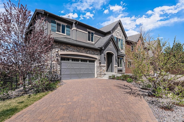 7033 E Lake Cir, Centennial, CO 80111 - craftsman-style house featuring fence, an attached garage, stone siding, stucco siding, and decorative driveway