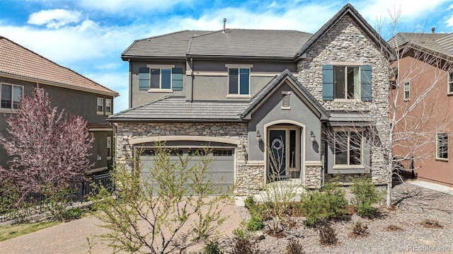 7033 E Lake Cir, Centennial, CO 80111 - craftsman-style home featuring fence, a garage, stucco siding, and stone siding