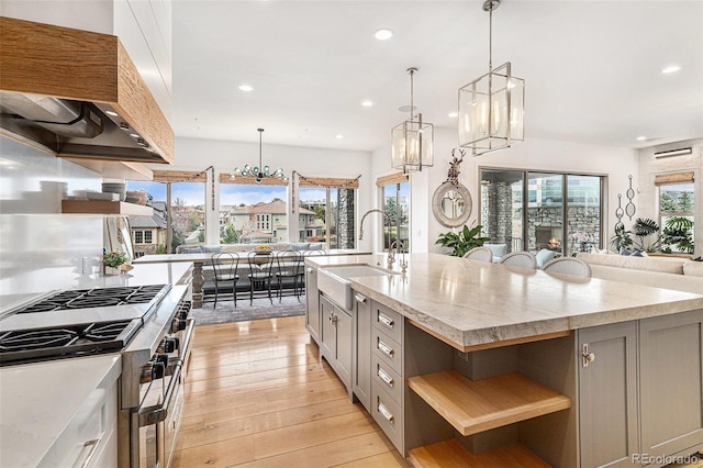 7033 E Lake Cir, Centennial, CO 80111 - kitchen featuring a sink, wall chimney exhaust hood, range with two ovens, gray cabinets, and recessed lighting