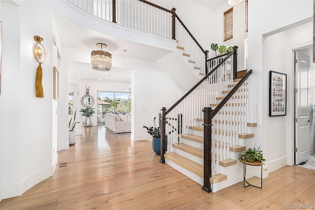 7033 E Lake Cir, Centennial, CO 80111 - foyer featuring a towering ceiling, visible vents, stairway, baseboards, and light wood-style floors