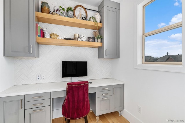 7033 E Lake Cir, Centennial, CO 80111 - office area with built in desk, light wood-style flooring, and baseboards