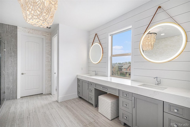 7033 E Lake Cir, Centennial, CO 80111 - full bathroom with a sink, double vanity, a notable chandelier, and a stall shower