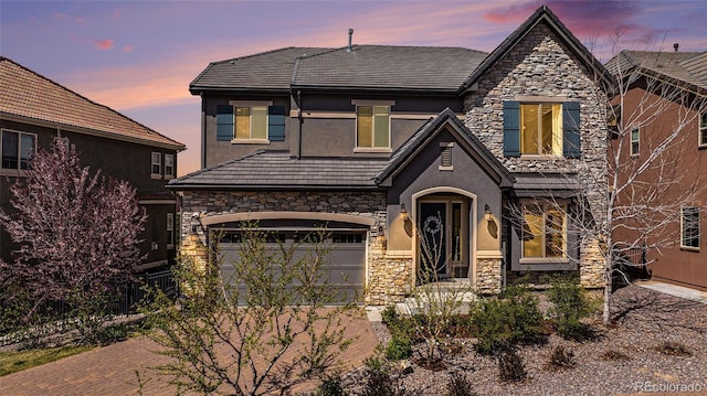7033 E Lake Cir, Centennial, CO 80111 - view of front of house with stone siding, stucco siding, driveway, and a garage