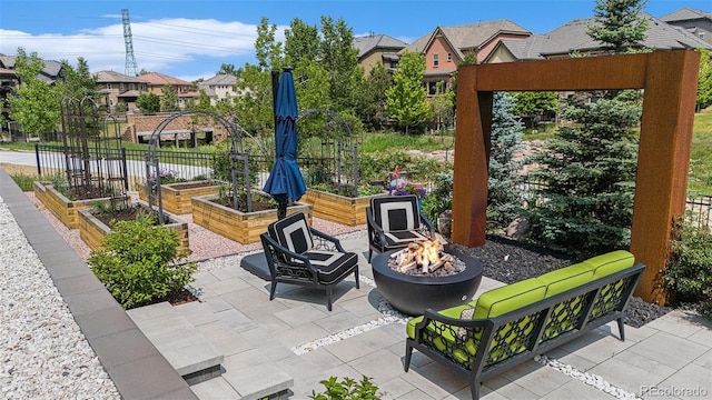 7033 E Lake Cir, Centennial, CO 80111 - view of patio with a garden, an outdoor fire pit, and a residential view