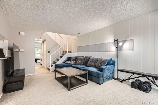 2896 W 119th Ave, Westminster, CO 80234 - living room featuring light carpet, stairs, and a textured ceiling