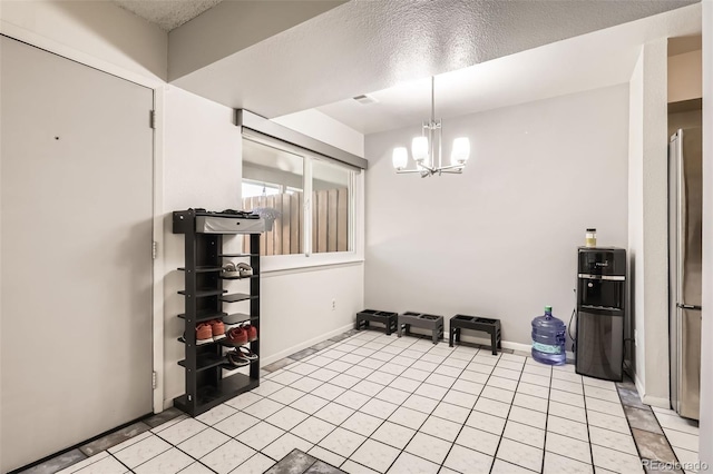 2896 W 119th Ave, Westminster, CO 80234 - unfurnished dining area with a chandelier, light tile patterned flooring, and a textured ceiling