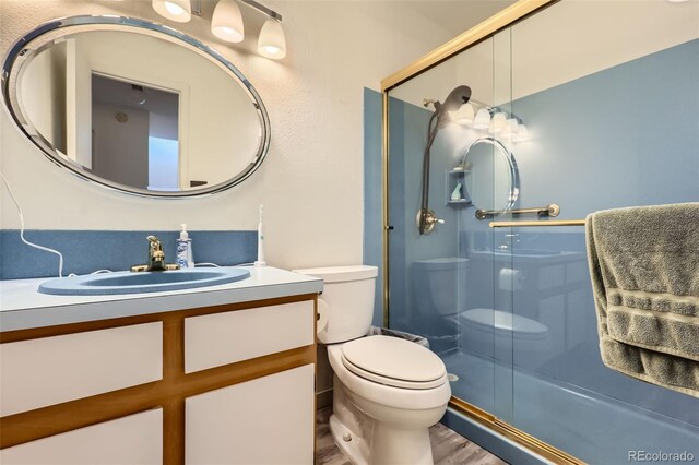 2896 W 119th Ave, Westminster, CO 80234 - full bathroom with vanity, wood finished floors, and a shower with door