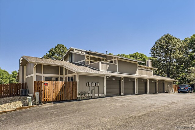 2896 W 119th Ave, Westminster, CO 80234 - mid-century modern home featuring a balcony, a chimney, and community garages