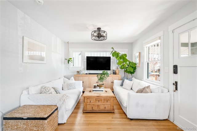 4401 Vrain St, Denver, CO 80212 - living room featuring plenty of natural light, light wood-style flooring, and a chandelier