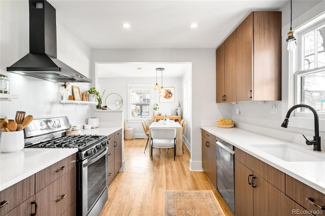 4401 Vrain St, Denver, CO 80212 - kitchen with stainless steel appliances, wall chimney range hood, light wood-style flooring, plenty of natural light, and recessed lighting