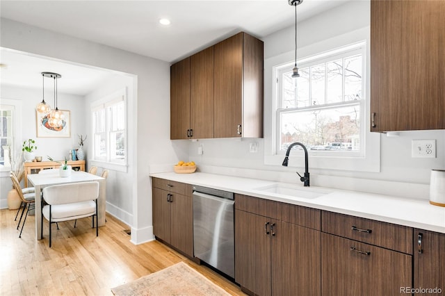 4401 Vrain St, Denver, CO 80212 - kitchen with dishwasher, light wood-type flooring, light countertops, hanging light fixtures, and recessed lighting