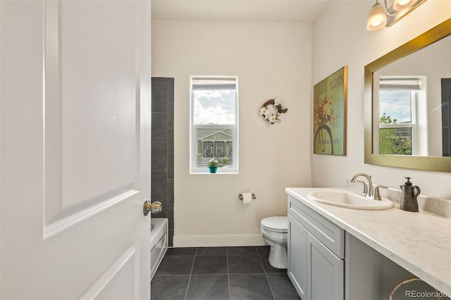 bathroom featuring tile flooring, toilet, and vanity with extensive cabinet space